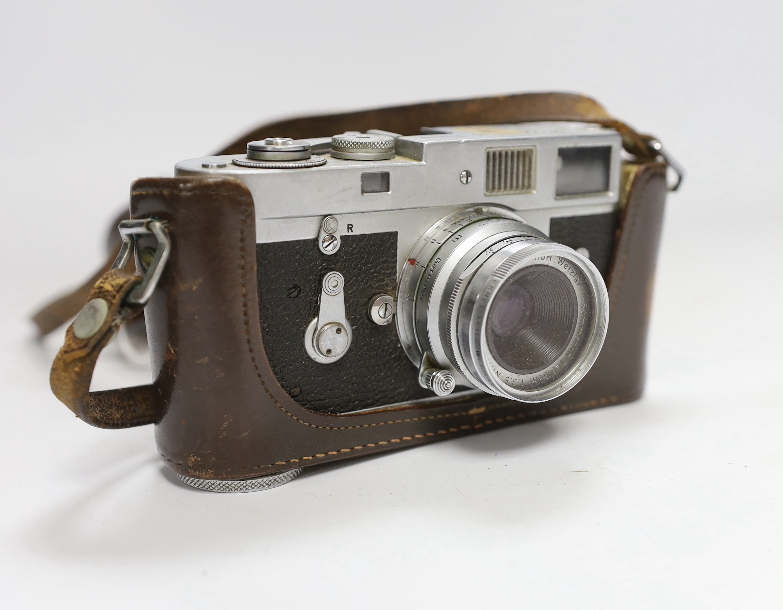A Leica M2 camera, serial no. 1104070, c.1965, with Summaron f=3.5cm 1:3.5 lens, with leather case and strap